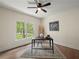 Home office with a desk, rug, and a window overlooking the yard at 6615 Callanwalde Ct, Suwanee, GA 30024