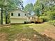 Backyard view of the home with a wooden deck and a green lawn at 75 Davis Mill Dr, Dallas, GA 30157