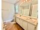 Bright bathroom featuring a double sink vanity, large mirror, and tiled floor at 75 Davis Mill Dr, Dallas, GA 30157