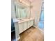 Bathroom with a double sink vanity, white cabinets and a large mirror at 75 Davis Mill Dr, Dallas, GA 30157