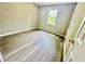 Bedroom featuring wood floors, fresh paint, and a window for natural light at 75 Davis Mill Dr, Dallas, GA 30157