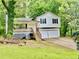 Exterior of the home with a two car garage, white siding, and a front porch at 75 Davis Mill Dr, Dallas, GA 30157