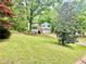 Charming two-story home featuring a well-maintained lawn and beautiful mature trees, enhancing its curb appeal at 75 Davis Mill Dr, Dallas, GA 30157