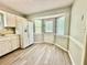 Bright kitchen with a white refrigerator, wood floors, and lots of light from the door and windows at 75 Davis Mill Dr, Dallas, GA 30157