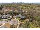 Stunning aerial view of estate home, showcasing lush greenery and a cityscape backdrop at 810 Kenry Ct, Atlanta, GA 30342