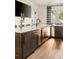 Modern bar area with custom cabinets, marble countertops, and an elegant faucet at 810 Kenry Ct, Atlanta, GA 30342