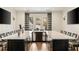 Entertaining bar area with marble counters, custom cabinetry, and seating for multiple guests at 810 Kenry Ct, Atlanta, GA 30342