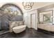 Luxurious bathroom with herringbone floors, soaking tub, dual shower heads, and large vanity at 810 Kenry Ct, Atlanta, GA 30342