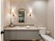 Powder room features wallpaper, gray vanity, sink, and toilet at 810 Kenry Ct, Atlanta, GA 30342