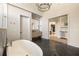 Luxurious bathroom with herringbone floors, soaking tub, access to adjacent rooms at 810 Kenry Ct, Atlanta, GA 30342