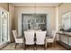 A formal dining area with a view looking into another room showcases a modern chandelier and artwork at 810 Kenry Ct, Atlanta, GA 30342