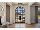 Elegant foyer with a soaring arched doorway and view of the front lawn and driveway at 810 Kenry Ct, Atlanta, GA 30342