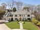 Stunning home showcasing meticulous landscaping, a manicured lawn, and a stone walkway leading to the arched entry at 810 Kenry Ct, Atlanta, GA 30342
