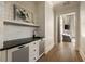 Hallway view with decorative wallpaper and wet bar featuring a sink, counter, and drawers at 810 Kenry Ct, Atlanta, GA 30342