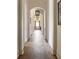 Elegant hallway featuring arched doorways, hardwood floors, recessed lighting and stylish pendant lighting, creating a seamless flow at 810 Kenry Ct, Atlanta, GA 30342