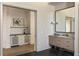 Hallway view with decorative wallpaper, wet bar, and bathroom vanity with large mirror at 810 Kenry Ct, Atlanta, GA 30342