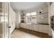 Modern kitchen with white cabinets, a large window, and stainless-steel appliances offers a functional design at 810 Kenry Ct, Atlanta, GA 30342