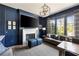 Comfortable living room with dark blue walls, a fireplace, a large window, and modern furnishings at 810 Kenry Ct, Atlanta, GA 30342