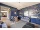 Stylish living area with a bar area, comfortable seating, a decorative chandelier, and elegant blue accents at 810 Kenry Ct, Atlanta, GA 30342