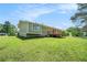 Exterior home view with spacious backyard, lawn, and blue sky at 898 Doeskin Nw Dr, Conyers, GA 30012