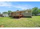 Exterior home view with backyard, deck, and blue sky at 898 Doeskin Nw Dr, Conyers, GA 30012