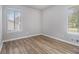 Inviting bedroom featuring natural light, modern wood-look flooring, and neutral walls, creating a serene retreat at 898 Doeskin Nw Dr, Conyers, GA 30012