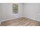 Charming bedroom with wood-look flooring, natural light, and neutral walls, providing a peaceful and inviting space at 898 Doeskin Nw Dr, Conyers, GA 30012
