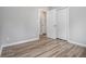 Spacious bedroom with wood-look flooring, neutral walls, and closet space at 898 Doeskin Nw Dr, Conyers, GA 30012