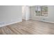 Comfortable bedroom with modern wood-look flooring and ample light, a tranquil space for rest and rejuvenation at 898 Doeskin Nw Dr, Conyers, GA 30012
