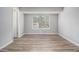 Bright bedroom featuring sleek wood-look floors, neutral walls, and natural light, perfect for relaxation at 898 Doeskin Nw Dr, Conyers, GA 30012
