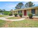 Charming home featuring well-kept landscaping and a walkway to the inviting red front door at 898 Doeskin Nw Dr, Conyers, GA 30012