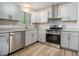 Updated kitchen features stainless steel appliances, modern grey cabinets, and durable countertops at 898 Doeskin Nw Dr, Conyers, GA 30012