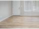 Bright and airy living area boasts new flooring, neutral paint, and plentiful natural light from the window at 898 Doeskin Nw Dr, Conyers, GA 30012