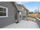 Exterior photo of a home's back deck with gray siding and steps to the yard at 101 Saddlehorn Ct, Woodstock, GA 30188