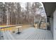 Back deck area with gray wooden rails, steps and table at 101 Saddlehorn Ct, Woodstock, GA 30188