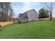 Back view of the house showing a large grassy lawn and gray siding at 101 Saddlehorn Ct, Woodstock, GA 30188