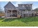 The backyard with multi-level gray decks and a large green lawn at 101 Saddlehorn Ct, Woodstock, GA 30188