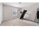 Neutral bedroom with window, carpet, closet and a treadmill for exercise at 101 Saddlehorn Ct, Woodstock, GA 30188