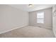 Cozy bedroom featuring plush carpeting, natural light, and neutral paint at 101 Saddlehorn Ct, Woodstock, GA 30188