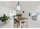 Bright dining area features stylish light fixture, tile floors, and bar stool seating at 101 Saddlehorn Ct, Woodstock, GA 30188