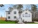 Charming two-story white brick home with symmetrical design, dormers, blue shutters, and a well-manicured lawn at 101 Saddlehorn Ct, Woodstock, GA 30188