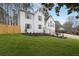 Beautifully landscaped yard surrounds this white brick two-story home, complete with manicured lawn and black mulch flower beds at 101 Saddlehorn Ct, Woodstock, GA 30188