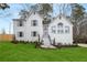 Charming two-story home featuring a white brick exterior, well-manicured lawn, and elegant front entrance at 101 Saddlehorn Ct, Woodstock, GA 30188