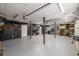 Spacious garage with ample storage shelves and a pristine, durable-looking floor for parking and projects at 101 Saddlehorn Ct, Woodstock, GA 30188
