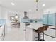 Stylish kitchen with white cabinets, an island with seating, and a modern refrigerator for a sleek design at 101 Saddlehorn Ct, Woodstock, GA 30188