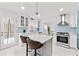 Bright kitchen featuring modern appliances, an island with seating, and access to an outdoor deck at 101 Saddlehorn Ct, Woodstock, GA 30188