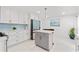 Modern kitchen with white cabinetry, stylish island, and stainless steel appliances offers a functional design at 101 Saddlehorn Ct, Woodstock, GA 30188