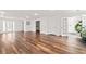 Spacious room featuring stylish wood floors, double glass doors and white walls at 101 Saddlehorn Ct, Woodstock, GA 30188