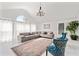 Bright living room with vaulted ceiling, large windows, stylish furnishings, and an elegant area rug at 101 Saddlehorn Ct, Woodstock, GA 30188