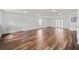 Open-concept living room with gleaming wood floors and recessed lighting at 101 Saddlehorn Ct, Woodstock, GA 30188